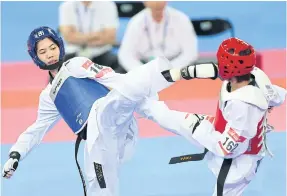  ??  ?? Taekwondo star Panipak Wongpattan­akit, left, in action at the 2014 Asian Games.