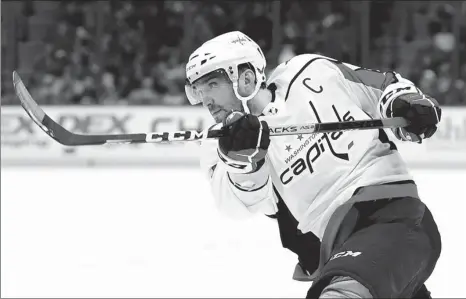  ?? AP ?? Washington Capitals left wing Alex Ovechkin, follows through on a shot against the Tampa Bay Lightning during a game in Tampa, Florida in 2019. The 36-year-old Ovechkin is starting a new five-year contract as he chases Wayne Gretzky’s all-time NHL scoring record of 894 goals; the Russian needs 165 to pass Gretzky.