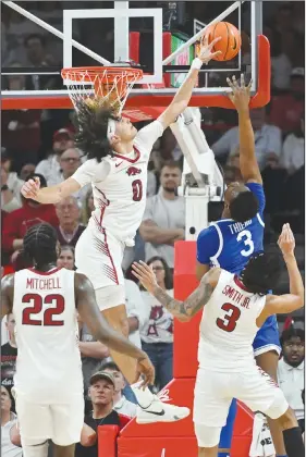  ?? Associated Press ?? Rejected: Arkansas guard Anthony Black (0) blocks the shot of Kentucky guard Adou Thiero (3) during an NCAA college basketball game Saturday in Fayettevil­le.