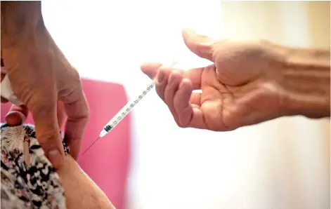  ?? — AFP photo ?? A woman receives a dose of the Pfizer-BioNTech vaccine against the coronaviru­s at the Clermont-Tonnerre military hospital (HIA) in Brest, western France, on April 6, 2021, during a vaccinatio­n campaign to fight the Covid-19 pandemic.