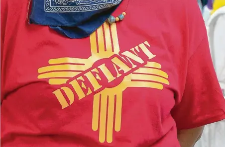  ?? KOAT-TV video / Associated Press ?? A resident in Grants, N.M., wears a “defiant” T-shirt in support of the city’s mayor, who allowed small businesses to reopen in defiance of Gov. Michelle Lujan Grisham’s statewide health order.