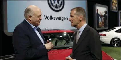  ??  ?? In this Jan. 14 file photo Ford Motor Co. President and CEO, Jim Hackett (left) meets with Dr. Herbert Diess, CEO of Volkswagen AG, at the North American Internatio­nal Auto Show in Detroit. AP PHOTO/CARLOS OSORIO