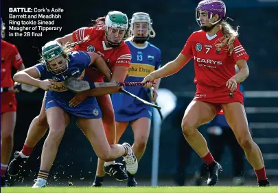  ?? ?? BATTLE: Cork’s Aoife Barrett and Meadhbh Ring tackle Sinead Meagher of Tipperary in the 2B final