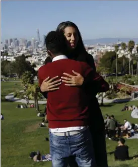  ?? JEFF CHIU — THE ASSOCIATED PRESS ?? Julie Rajagopal, facing, hugs her 16-year-old foster child from Eritrea after posing for photos at Dolores Park in San Francisco.