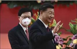  ?? SELIM CHTAYTI — POOL PHOTO ?? Hong Kong’s new Chief Executive John Lee, left, walks with China’s President Xi Jinping following Xi’s speech after a ceremony to inaugurate the city’s new leader and government in Hong Kong on Friday on the 25th anniversar­y of the city’s handover from Britain to China.