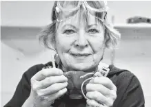  ?? ELIZABETH PATTERSON • CAPE BRETON POST ?? Jewelry maker Lynda Lou Macintyre holds a bar of silver and the hand-made silver bracelet that can result from it.
