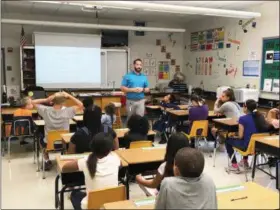  ??  ?? Pottstown Middle School math and science teacher Sam DiAngeli informs his students of the rules of decorum and behavior before classes got started Aug. 27.