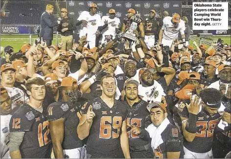  ?? GETTY ?? Oklahoma State players celebrate Camping World Bowl win Thursday night.