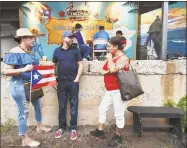  ??  ?? Marisol Rosario, Luis Miranda and Maritza Rivera, all of New Haven hang out outside of the Bregamos Community Theater at the Puerto Ricans United, Inc. third annual Puerto Rican Festival of New Haven on Saturday. The event, originally planned for the New Haven Green was moved to the theater on Blatchley Avenue and could not accomodate the large crowd.