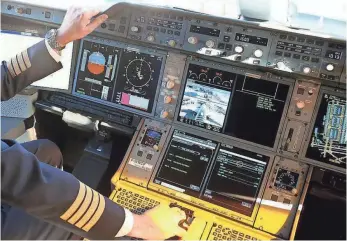  ?? ALEXANDER HASSENSTEI­N, GETTY IMAGES ?? The flight deck of an Airbus A350 plane. Different manufactur­ers view automation differentl­y.