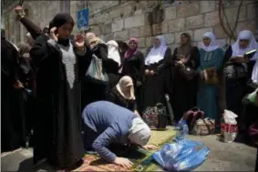  ?? ODED BALILTY — THE ASSOCIATED PRESS ?? Palestinia­n women pray at the Lion’s Gate following an appeal from clerics to pray in the streets instead of the Al Aqsa Mosque compound, in Jerusalem’s Old City, Tuesday, July 25, 2017. Dozens of Muslims have prayed in the street outside a major...