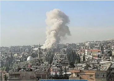  ?? /Reuters ?? Damascus blast: Smoke rises after a missile strike on Damascus, Syria, which killed members of Iran's Revolution­ary Guards. A source in Lebanon said an Israeli strike there killed a member of Iranian-backed Hezbollah.