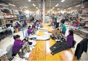  ?? Ivan Pierre Aguirre / Associated Press file ?? Workers manufactur­e car dash mats in Ciudad Juarez. In Mexico, where the auto industry has boomed under NAFTA, the industry has created a class of workers who are barely getting by.