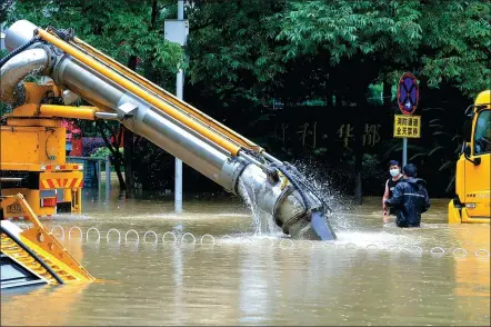  ?? ZHANG CHANG / CHINA NEWS SERVICE ?? A vehicle pumps floodwater­s from a street in Wuhan’s Hongshan district, Hubei province, on Monday. City authoritie­s have issued alerts for floods after recent storms, which have brought heavy rains. Provisions have been made to help students deal with the bad weather as they take the national college entrance exam, or gaokao, which starts on Tuesday in Wuhan and around the country.