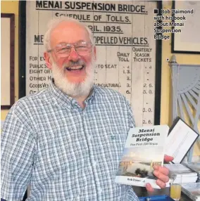  ??  ?? ■ Bob Daimond with his book about Menai Suspension Bridge
