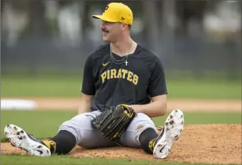  ?? Benjamin B. Braun/Post-Gazette ?? Pirates pitcher Paul Skenes sits down after losing his balance during drills at Pirate City on Friday during spring training in Bradenton, Fla. View more Friday photos at Post-Gazette.com.