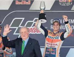  ?? AFP ?? Winner Dani Pedrosa celebrates next to former Spanish King Juan Carlos.