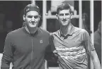  ?? JULIAN FINNEY/ GETTY IMAGES ?? Roger Federer, left, will play Novak Djokovic for the 50th time, this time in the Australian Open semifinals.