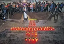  ?? AP PHOTO ?? Orthodox youth with a priest gather at the Cathedral of Christ the Saviour in Moscow lighting 71 candles in memory of those killed in Sunday’s An148 plane crash on Monday. A Russian passenger plane carrying 71 people crashed Sunday near Moscow, killing...