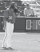  ?? LYNNE SLADKY/AP ?? Nationals pitcher Trevor Williams prepares to throw as the pitch clock runs during a spring training game on Saturday.