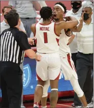  ?? (NWA Democrat-Gazette/Andy Shupe) ?? Arkansas guard Jalen Tate reacts after being ejected from Wednesday’s game by official Doug Shows (left) during the second half of the No. 20 Razorbacks’ 81-66 victory over the No. 6 Alabama Crimson Tide at Walton Arena in Fayettevil­le. Alabama’s John Petty was also ejected from the game. More photos at arkansason­line.com/225alaua/.