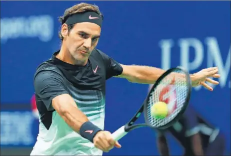  ?? AFP ?? Roger Federer returns to Feliciano Lopez during their third round US Open match at the Billie Jean King National Tennis Center, New York on Saturday.