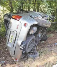  ?? Photos by Blake Doss, Rome News-Tribune ?? LEFT: A wrecker pulls a flipped vehicle back onto its wheels near Hiram Road on Ga. 140.