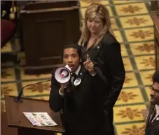  ?? George Walker IV/The Tennessean via AP ?? Tennessee state Rep. Justin Jones calls on his colleagues to pass gun control legislatio­n from the well of the House Chambers during the legislativ­e session at the state Capitol in Nashville on Thursday.