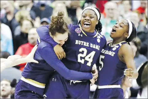  ?? GETTY IMAGES ?? Notre Dame’s Arike Ogunbowale (centre) is congratula­ted by teammates after scoring the title-winning basket with 0.1 seconds left.