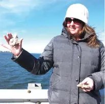  ?? Associated Press ?? ABOVE: Meredith Comi of the NY/NJ Baykeeper environmen­tal group holds oyster shells that are used in a project to protect the shoreline of Earle Naval Weapons Station in Middletown, N.J. Coastal communitie­s around the world are planting oyster reefs to...