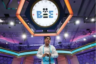  ?? AP Photo/Jacquelyn Martin ?? above Tejas Muthusamy, 14, of Glen Allen, Va., spells his word Thursday in the 90th Scripps National Spelling Bee in Oxon Hill, Md.