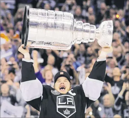  ??  ?? Los Angeles Kings captain Dustin Brown hoists the Stanley Cup after his team defeated the New Jersey Devils during Game 6 of the Stanley Cup final Monday night in Los Angeles.