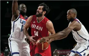  ?? ERIC GAY — THE ASSOCIATED PRESS ?? Iran’s Mohammadsa­mad Nik Khahbahram­i (14), center, drives between United States’ Draymond Green (14), left, and Khris Middleton (8) during men’s basketball preliminar­y round game at the 2020Summer Olympics, Wednesday, July 28, 2021, in Saitama, Japan.