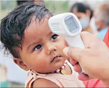  ?? PHOTO: PTI ?? A child being screened in Jammu on Thursday, as migrants from Chhattisga­rh gathered for medical certificat­es to return home