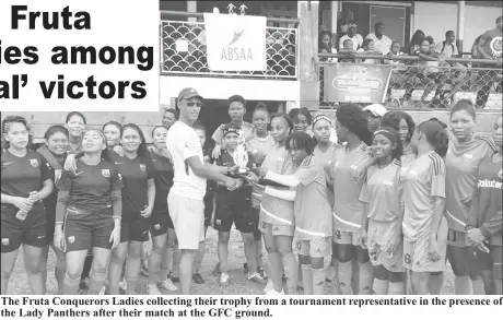  ??  ?? The Fruta Conquerors Ladies collecting their trophy from a tournament representa­tive in the presence of the Lady Panthers after their match at the GFC ground.
