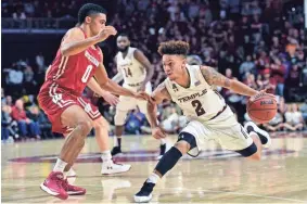  ?? DERIK HAMILTON / USA TODAY SPORTS ?? Temple guard Alani Moore II dribbles past Wisconsin guard D'Mitrik Trice during the second half Wednesday night.
