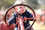  ?? NWA DEMOCRAT-GAZETTE/ J.T. WAMPLER ?? Drew White, 2, of Fort Worth gets to play on an antique tractor at the 20th annual Fall Tractor Show and Pull hosted by the Rustic Relics Antique Tractor Club. The show was held Oct. 17-18.