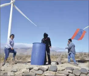  ?? JULIO MORALES PHOTO ?? Water Station board member Nikolai Beope (right) and two volunteers help replenish and mantain a water station in the desert north of Ocotillo on Saturday.