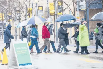  ?? ANDREWRUSH/PITTSBURGH POST-GAZETTE ?? People line up for a COVID-19 shot Thursday outside PNC Park in Pittsburgh. The U.S., which has ramped up vaccinatio­ns, is finalizing plans to send doses of AstraZenec­a vaccine to Canada and Mexico.