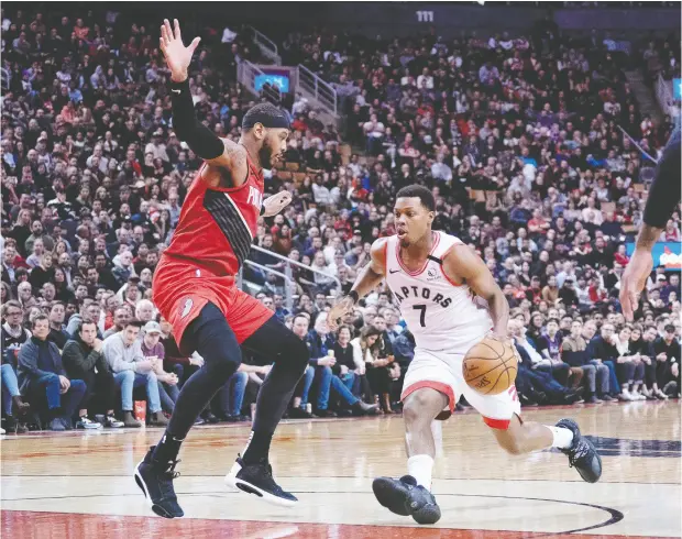  ?? Nick Turchiaro / USA TODAY Sports ?? Raptors guard Kyle Lowry controls the ball as Portland Trail Blazers forward Carmelo Anthony defends Tuesday night at Scotiabank Arena.