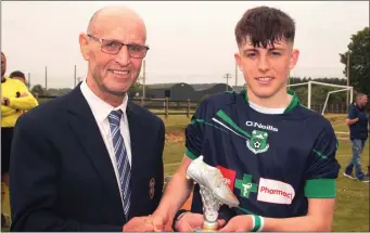  ??  ?? Willie Cottrell presents the man of the match trophy to Luke Kavanagh of Forth Celtic.