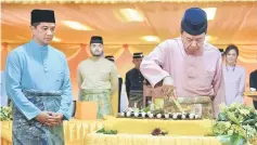  ??  ?? Sultan Sharafuddi­n cuts the cake in conjunctio­n with his birthday celebratio­n as Selangor MB Datuk Mohamad Azmin Ali (left) looks on. — Bernama photo