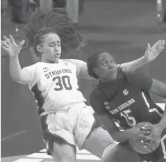  ?? MORRYGASH/AP ?? South Carolina forward Laeticia Amihere, right, charges into Stanford guard Haley Jones for an offensive foul during the second half of Friday’s women’s Final Four game at the Alamodome in San Antonio.