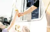  ?? ELLEN MORAN Getty Images ?? An excited little girl has just gotten a treat from an ice cream van.