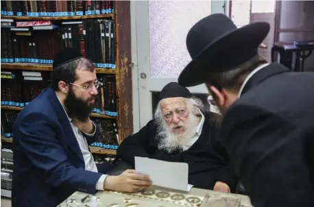  ?? (David Cohen/Flash90) ?? RAV CHAIM KANIEVSKY in his Bnei Brak home in December; grandson and chief aide Yanky is at left.
