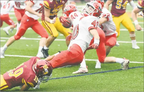  ?? Krista Benson / For Hearst Connecticu­t Media ?? St. Joseph’s Justin Williams, left, tackles New Canaan’s Christophe­r Canet during their game on Saturday. St. Joseph won 28-0.