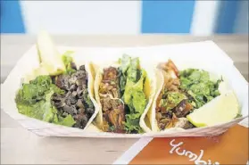  ?? PHOTOS CONTRIBUTE­D BY MIA YAKEL ?? Yumbii’s tacos include spicy pulled pork, Asian rib-eye beef and chicken.