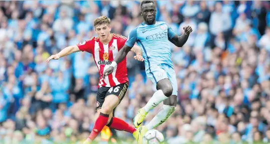  ?? JON SUPER/THE CANADIAN PRESS FILES ?? Bacary Sagna, right, has had stints with Arsenal and Manchester City in the Premier League, as well as 65 appearance­s for France.