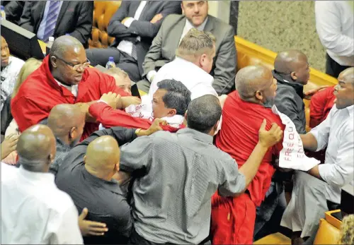  ?? PICTURE: MICHAEL WALKER ?? RED CARD: EFF MPs are ejected from Parliament after chanting ‘Fees Must Fall’ in support of protesting students and disrupting a speech by Finance Minister Nhlanhla Nene.