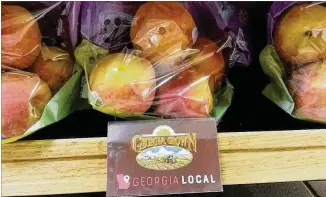  ?? MATT KEMPNER / AJC ?? Georgia farmers were expecting a big year for peaches — and blueberrie­s — this year after 2017’s bad weather. But peach farmers lost about half their crop this year to the cold.